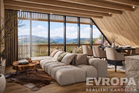 Prostorn� ob�vac� pokoj s modern�m designem, d�ev�n�m oblo�en�m a velk�mi okny nab�zej�c�mi panoramatick� v�hled na hory, parketov� podlaha, sv�tl� interi�r.